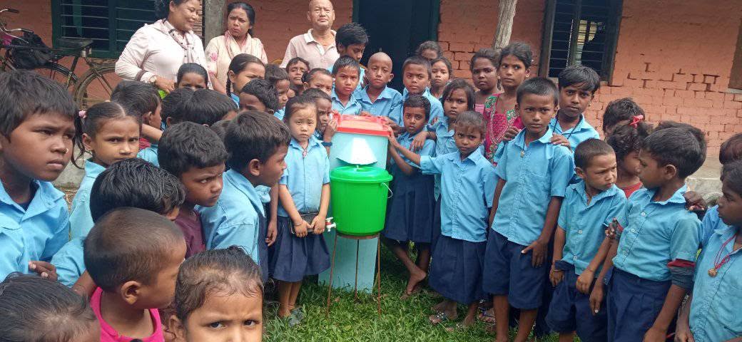 Students gathered around a Bio-Sand Filter during the Jadaha Rural Municipality school program